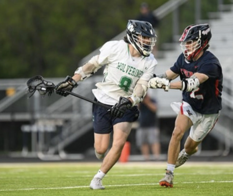 Yost attempts to run by a defender while looking for a goal.