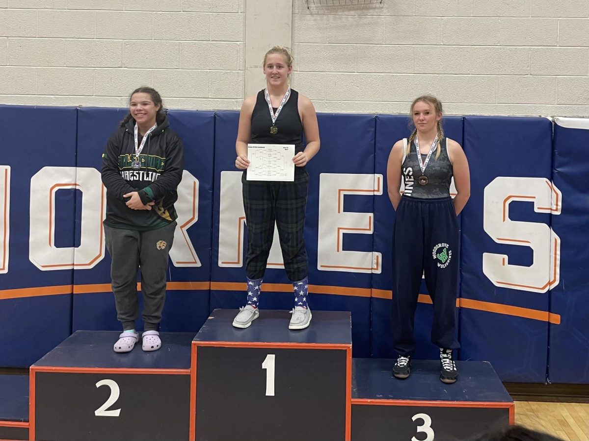 Morgan Musselman and other women wrestlers standing on the podium after a wrestling meet. Photo provided by Morgan Musselman. 