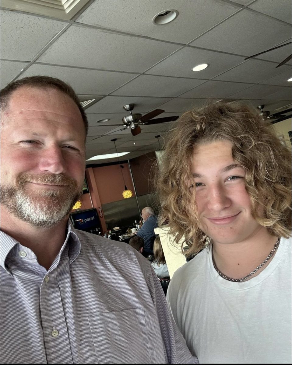 Grant Smith (right) stands with his dad, Justin Smith, after a review at Joe's Cafe in Leesburg VA. Photo provided by Grant Smith.
