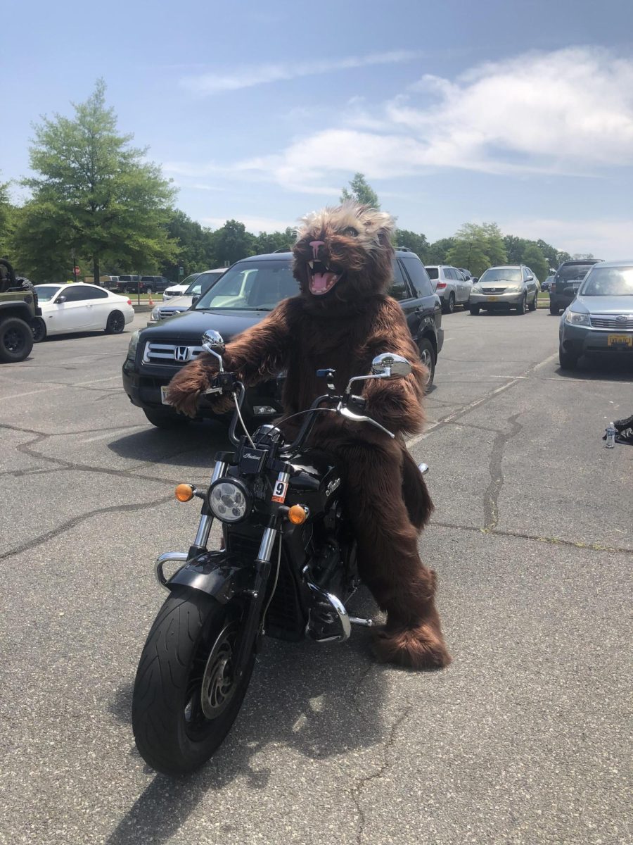 Walter Wolverine riding a motorcycle in the school parking lot. Photo provided by John Hays.