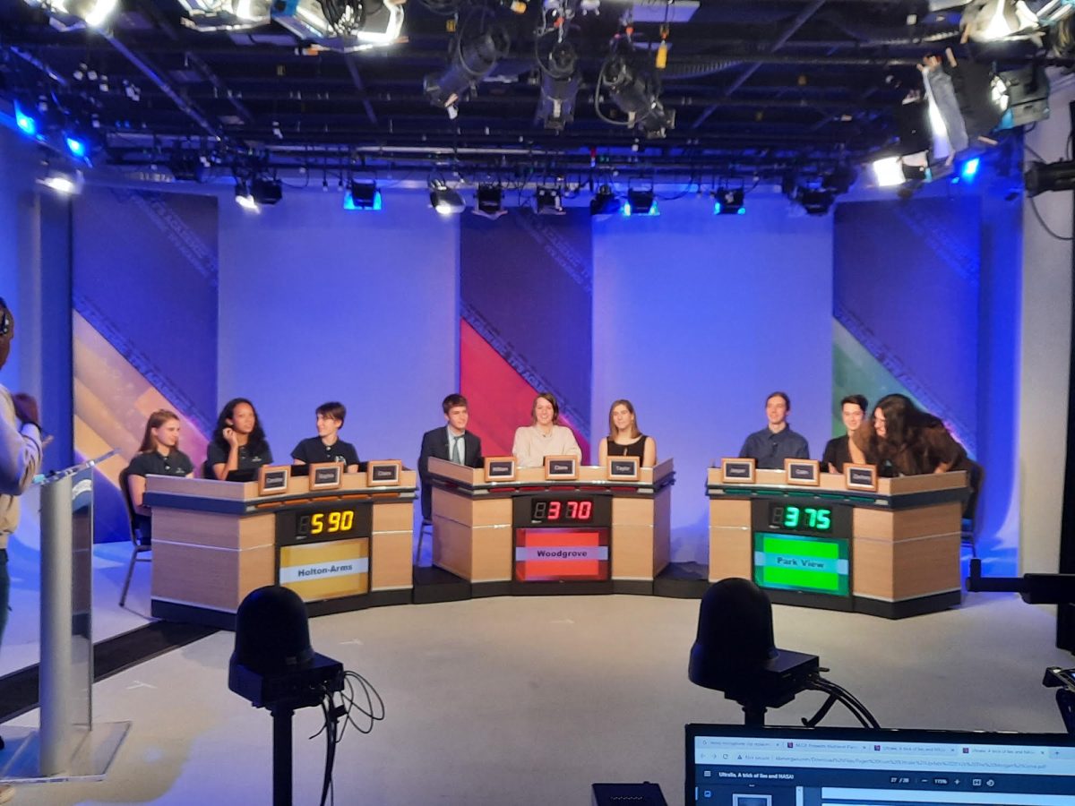 Former Junior William Den Herder, former senior Claire Harvey, and former senior Taylor Grande sit in front of the cameras to be featured in the 2023 episode of It's Academic. Photo provided by William Den Herder.