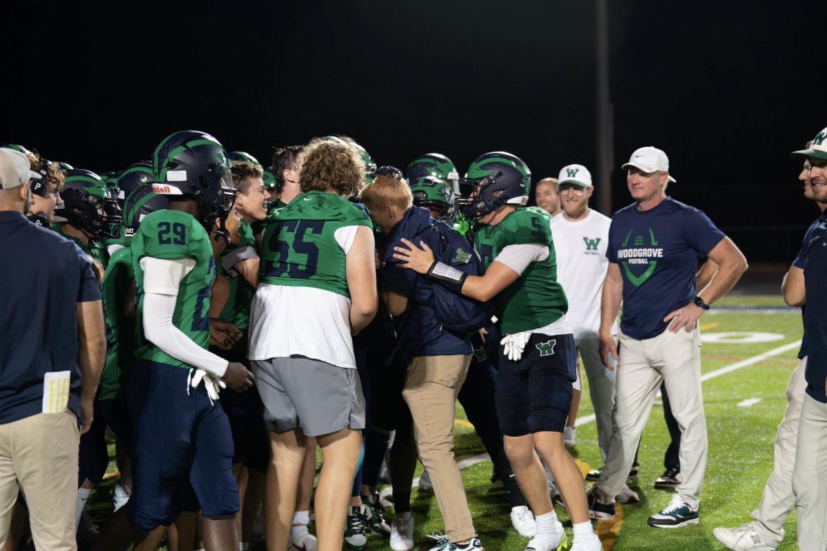 Coach Gargan in a team huddle with the football team after the Mountain View game on September 6. Photo provided by Sam Mesecar of Studio 1725 Photography.