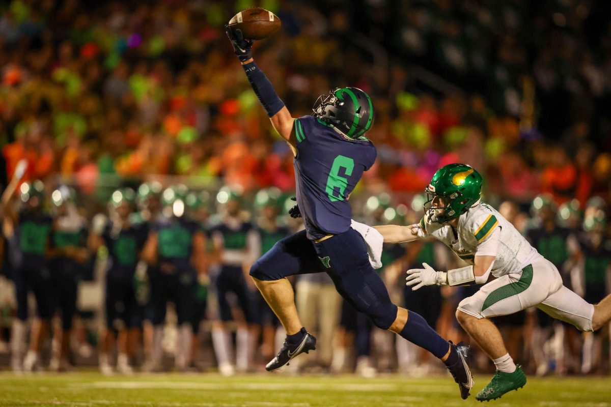 Junior Connor Salmin stretches to catch the football during the cross town rival game against Loudoun Valley on November 8. Photo provided by Steve Prakope of PlaidSheep Creative.
