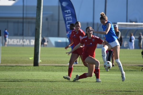 Senior Allie Flanagan kicks a soccer ball for FC Virginia. Photo provided by Amy Schneider.