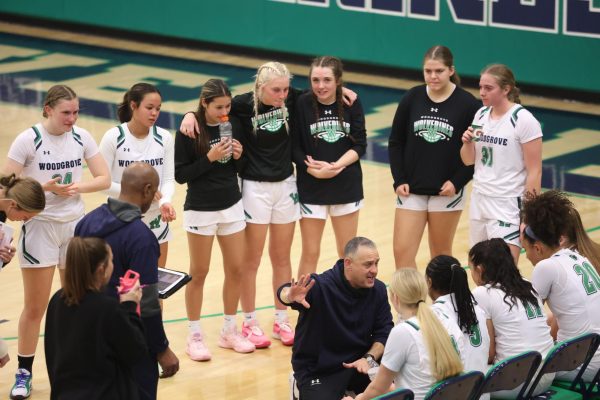 The Woodgrove Girls Varsity Basketball Team huddles together at halftime. Photo provided by Steve Prakope.