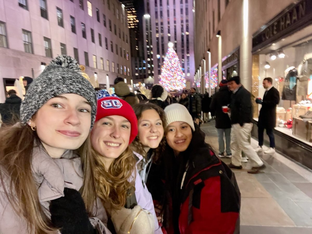 Juniors Megan Hamrick, Amelia Crush, Kaylie Halverson, Amanda Nguyen stand in front of the Rockefeller Center Christmas Tree.