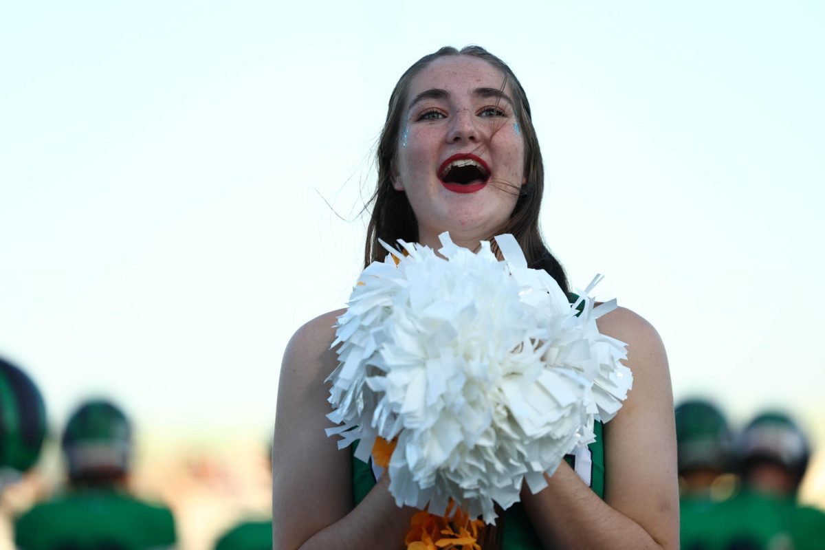 Kaylee Stanton cheering on the sideline for Varsity football. Photo provided by Steve Prakope.