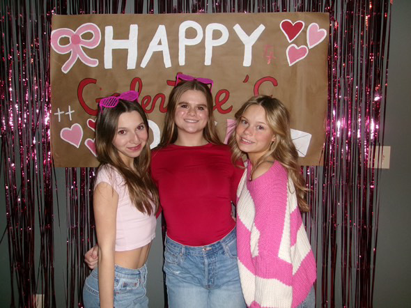 Pictured from left to right, freshman Delledonne, freshman Madison Oller, and sophomore Taylor Wilson pose for the camera in their red, pink, and white attire. Photo provided by Taylor Wilson.